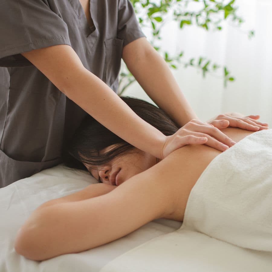 A person receiving a massage in a tranquil spa setting.