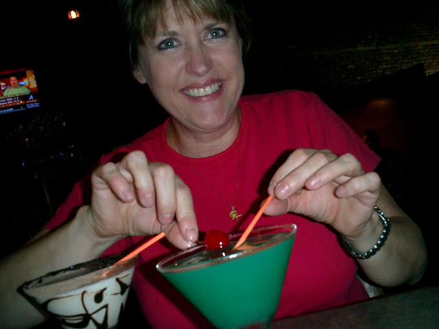 Pretty woman enjoying a green drink in a martini glass
