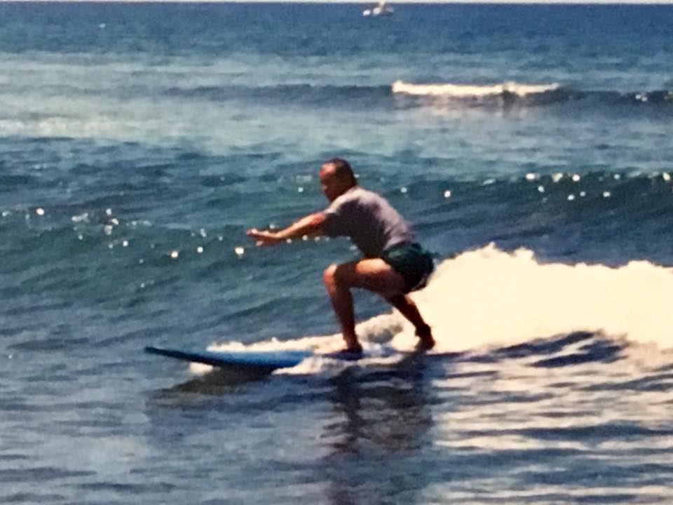 man on surfboard riding wave