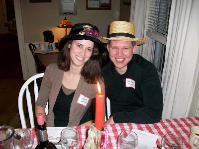 Woman and man wearing dress up hats near candle light