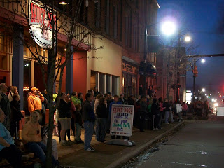 crowd of people on city street at night