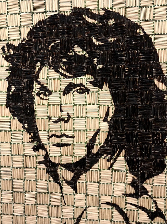 a patchwork of matchsticks with green tips that create a portrait of rock star Jim Morrison