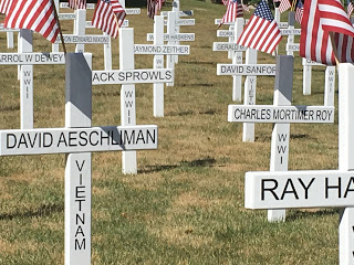 white crosses with names and era of fallen soldiers in Hillsdale County Michigan