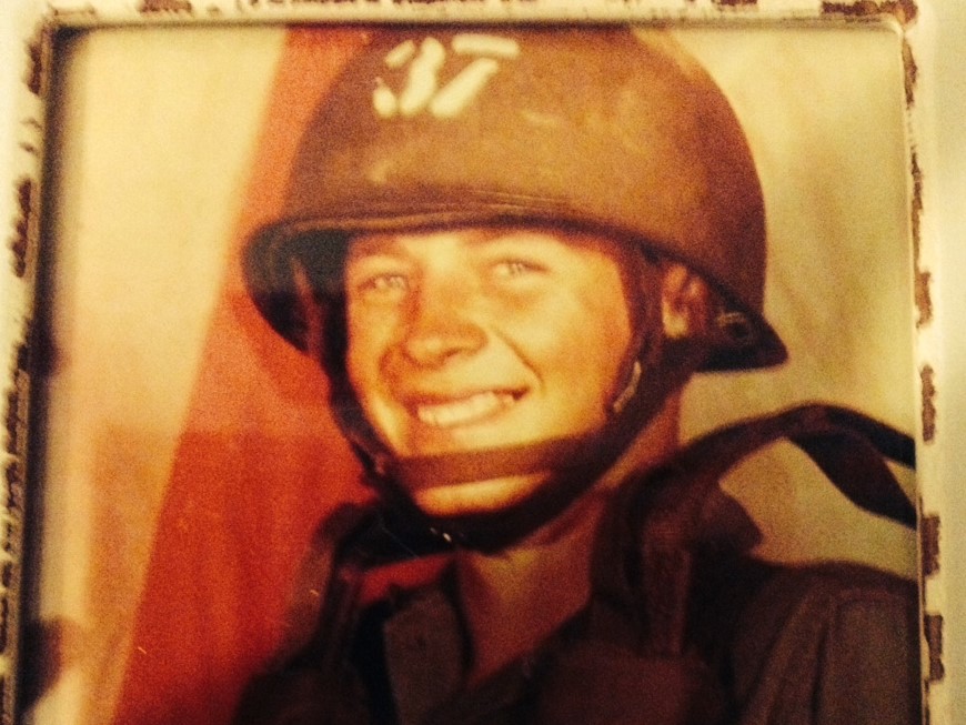 Old photograph of a smiling soldier wearing a helmet with number 37