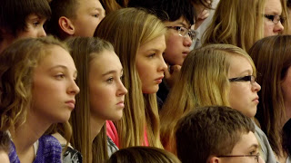 Students attend veterans day memorial service at Jonesville Michigan middle school gym