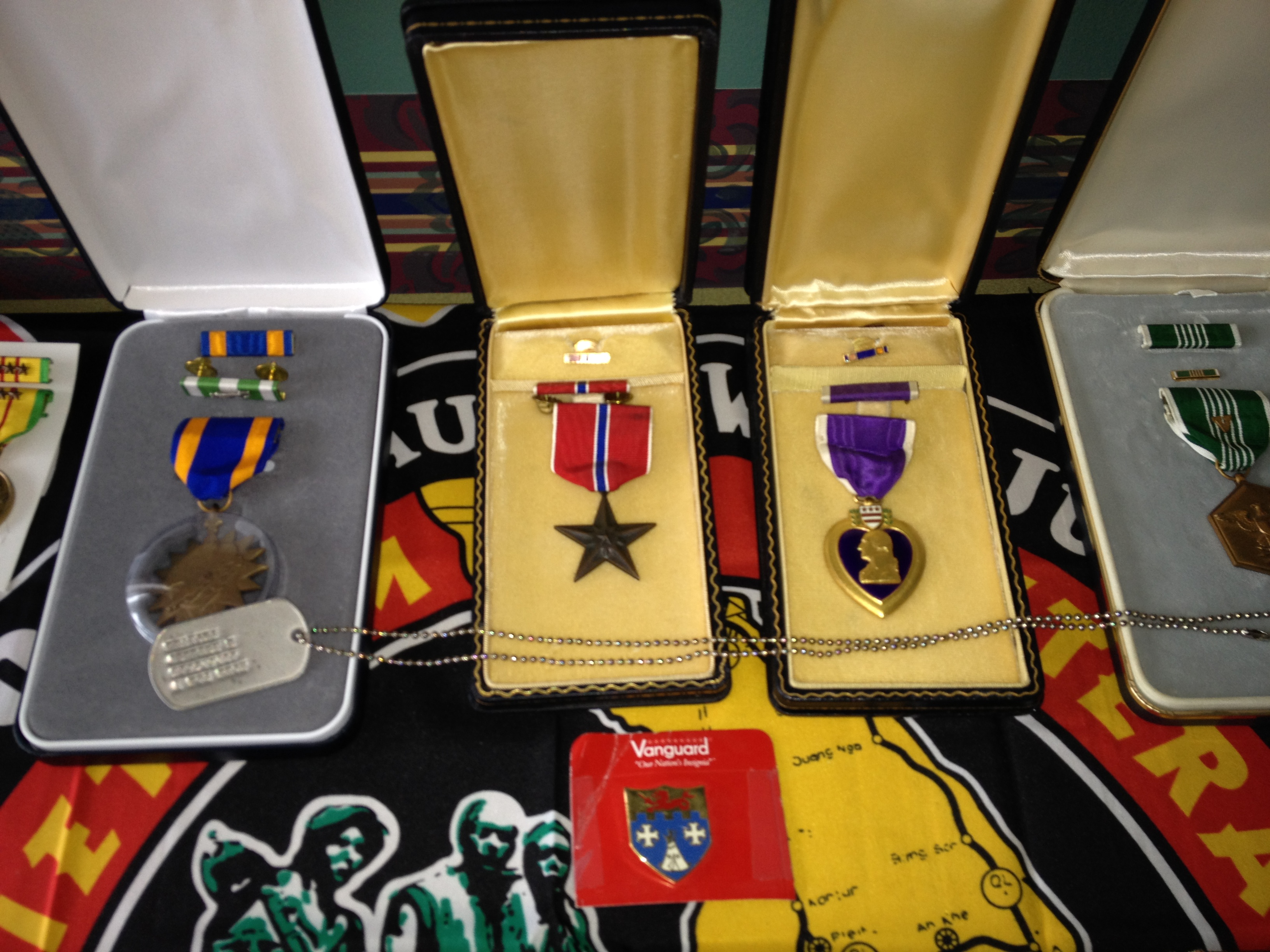 multiple military service medals in boxes