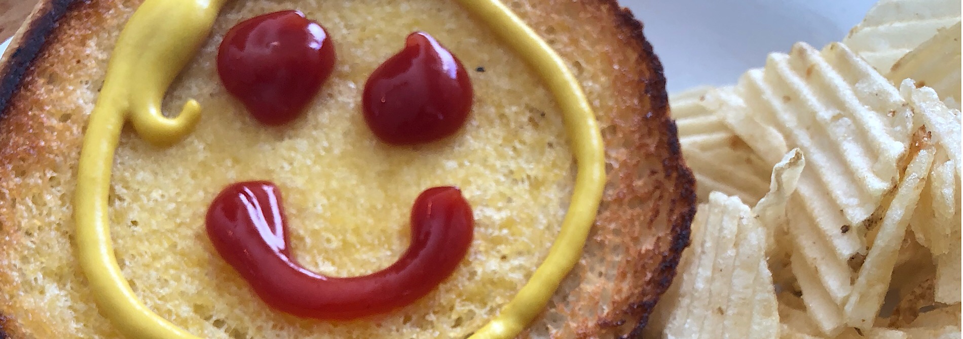 burger with happy face made from ketchup and mustard
