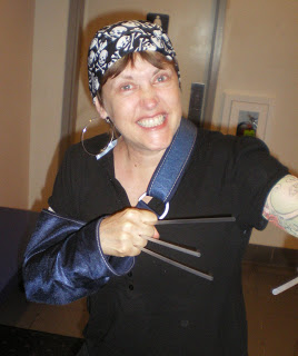woman pirate wearing dew rag, hoop earring and wolverine claws