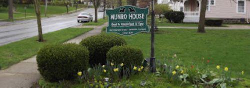 green and white munro house sign with yellow flowers