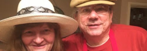 man in red shirt with woman in white hat