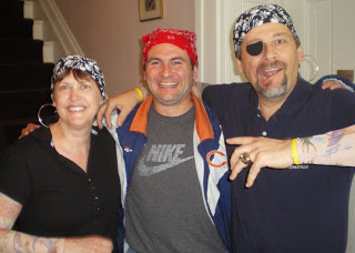 2 men and a woman dressed like pirates wearing dew rags and tattoo sleeves