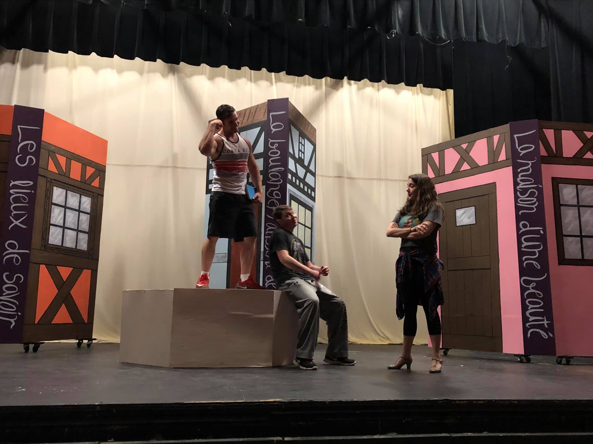 cast practicing musical production on stage